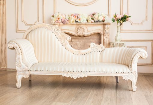 Classic Interior Of Living Room With Sofa And Armchair Near Fireplace