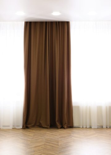 Windows with elegant curtains in modern room